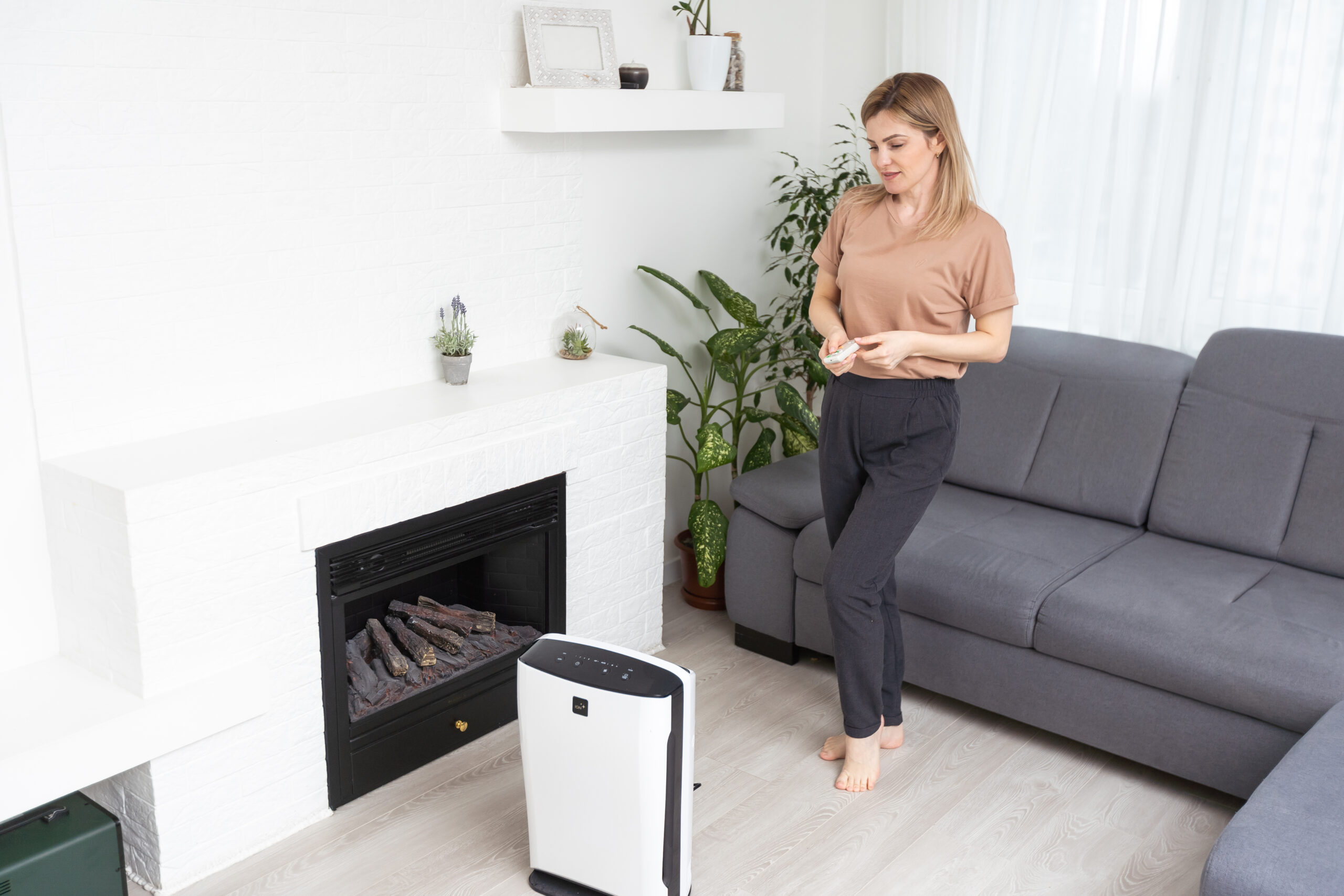 young casual woman using floor air conditioner for 2024 02 01 12 23 06 utc